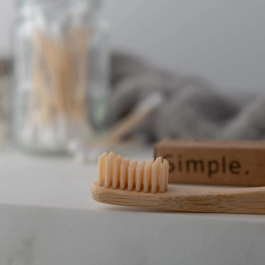 bamboo toothbrush and bamboo cotton swabs on eco-friendly countertop